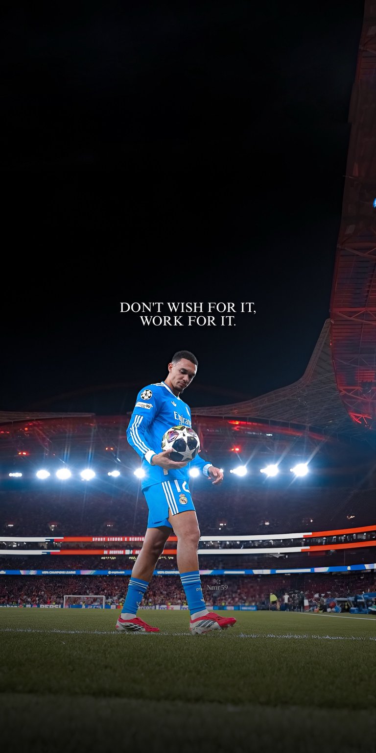 Trent Alexander-Arnold Static Wallpaper showcases the football star in a blue kit under bright stadium lights with sharp contrast and dramatic shadows. This aesthetic wallpaper looks striking on iPhone, making the wallpaper perfect for lock screen and home screen.