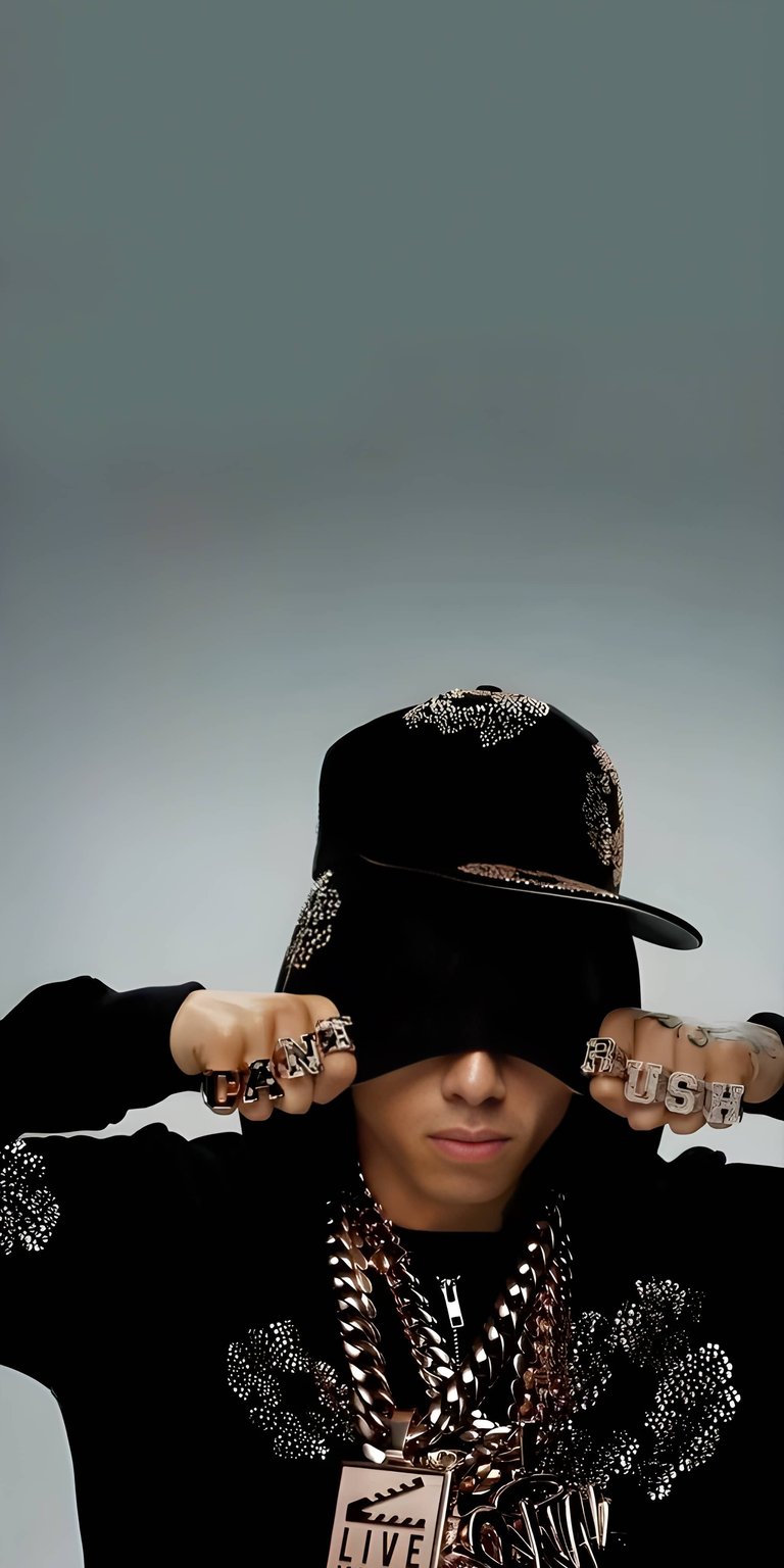 Aesthetic wallpapers featuring Lil Yachty in a high-contrast portrait wallpaper designed for iPhone lock and home screens. This wallpaper uses deep blacks, metallic gold jewelry, and moody studio lighting for a bold, cinematic look.