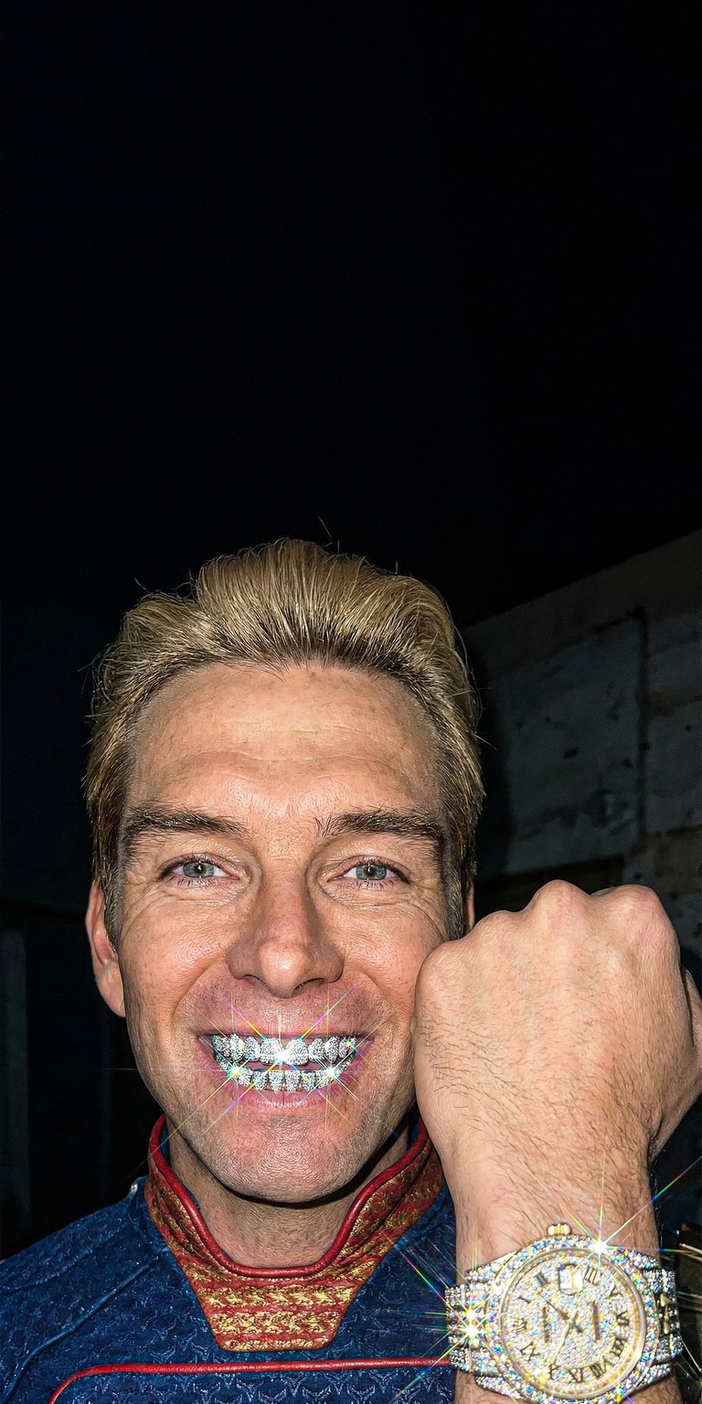 Elevate your iPhone with this premium Homelander 4K OLED wallpaper featuring the supe sporting custom diamond grillz and a matching iced-out watch. This high-contrast wallpaper showcases sharp textures and brilliant light glints against a deep black background for maximum visual impact.