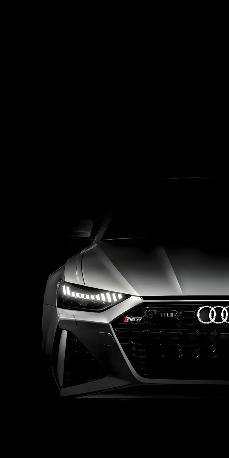 The front grille and sharp headlights of an Audi RS6 are highlighted in this high-contrast car wallpaper. This dark OLED wallpaper creates a stealthy, premium look for your iPhone.