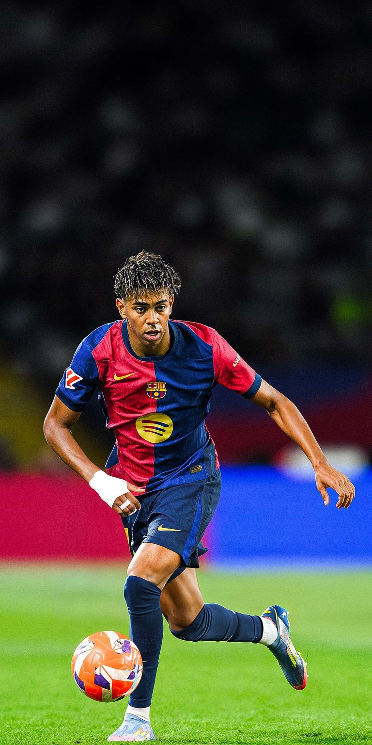 Lamine Yamal of FC Barcelona runs with the ball Wallpaper for iPhone