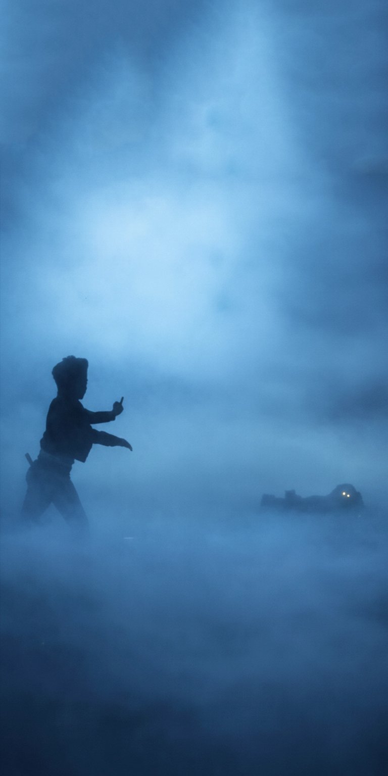 Download this eerie Mono Little Nightmares wallpaper in 4K for your iPhone, featuring a silhouette of Mono, thick fog, and a monster with glowing eyes. This stunning wallpaper captures the chilling atmosphere of the game, making it a unique addition to your device.