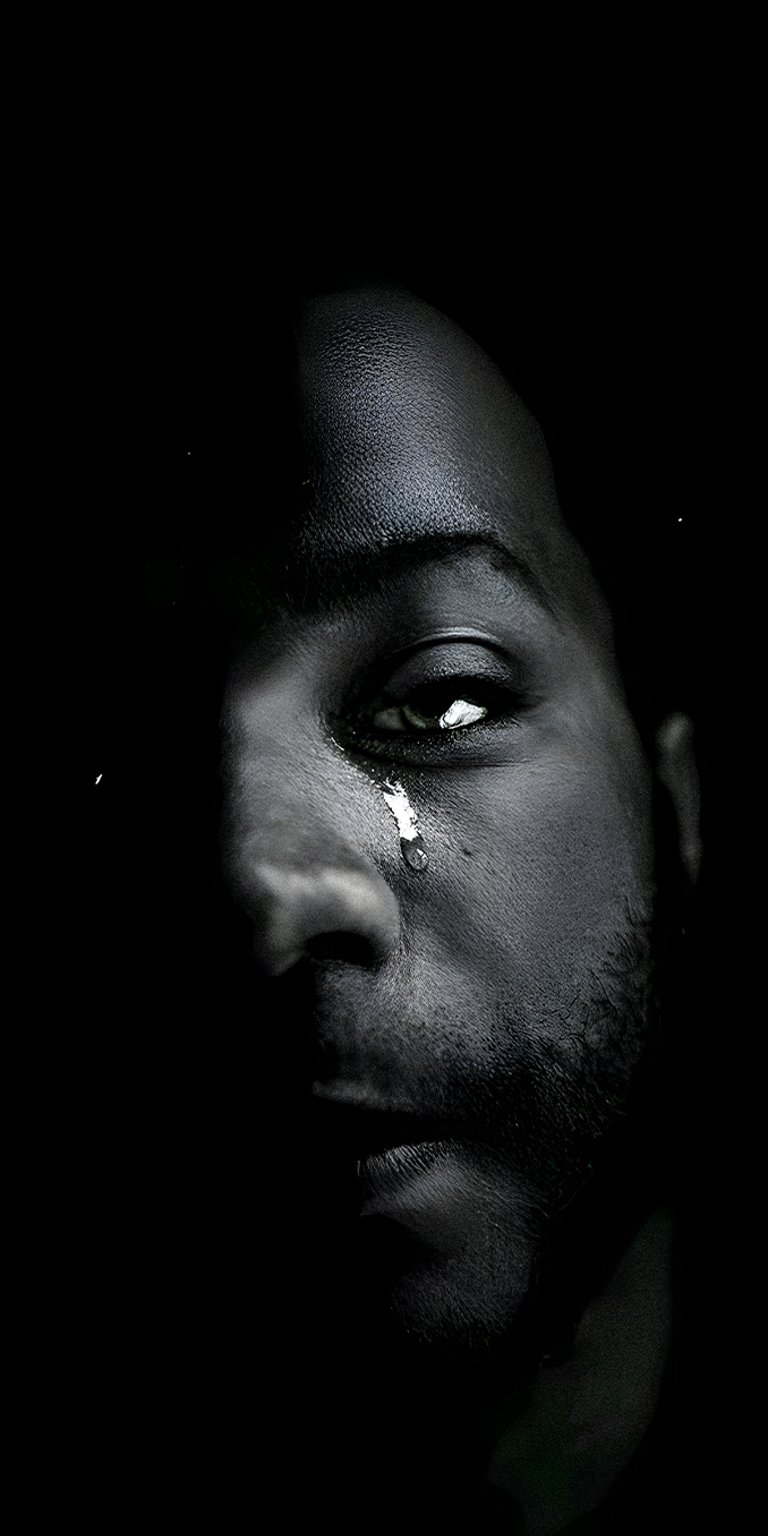Man crying with dark background wallpaper