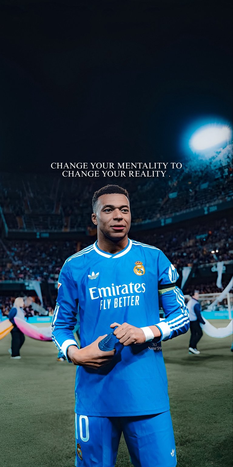This aesthetic wallpaper features Kylian Mbappé in a blue Real Madrid kit standing in a stadium under bright lights. Perfect for iPhone, this wallpaper captures a cinematic sports mood with a motivational quote and deep stadium shadows.