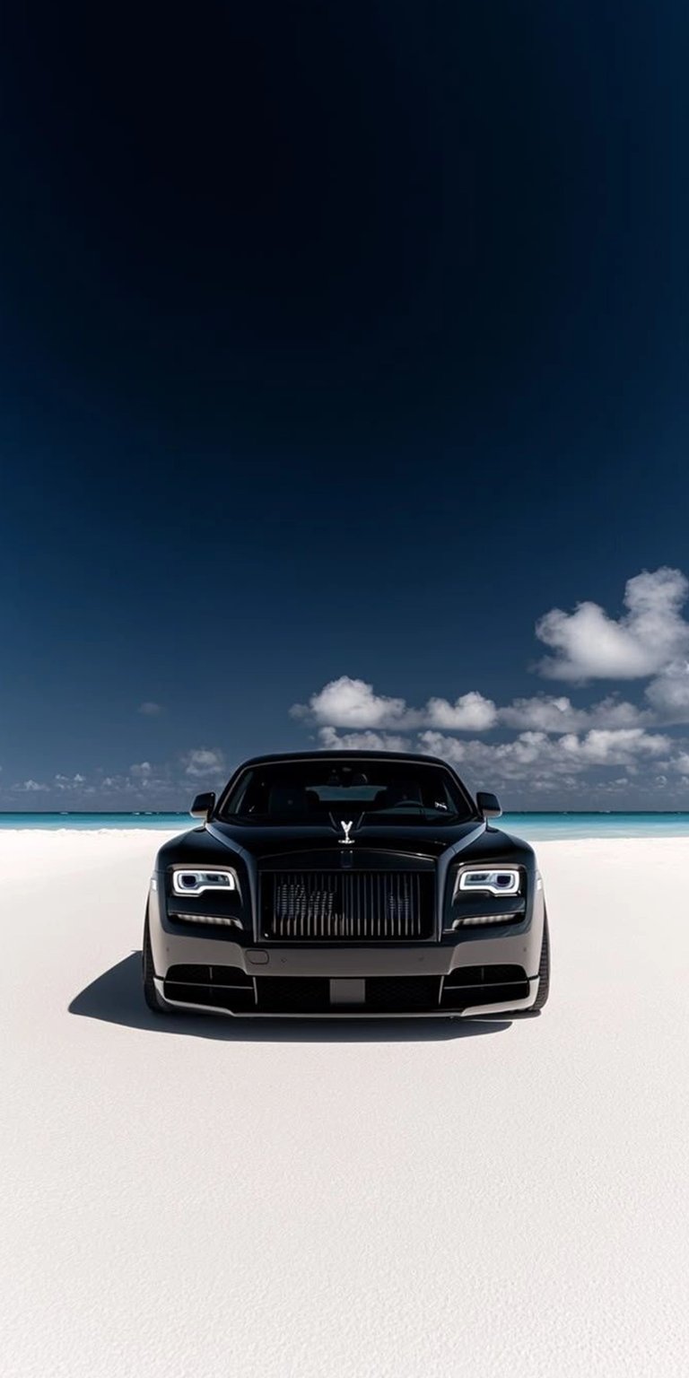 Download this stunning Rolls Royce wallpaper in 4K for your iPhone, showcasing the black luxury car against the turquoise ocean and cloud-dotted blue sky. The sleek grille and iconic Spirit of Ecstasy hood ornament add to the elegance.