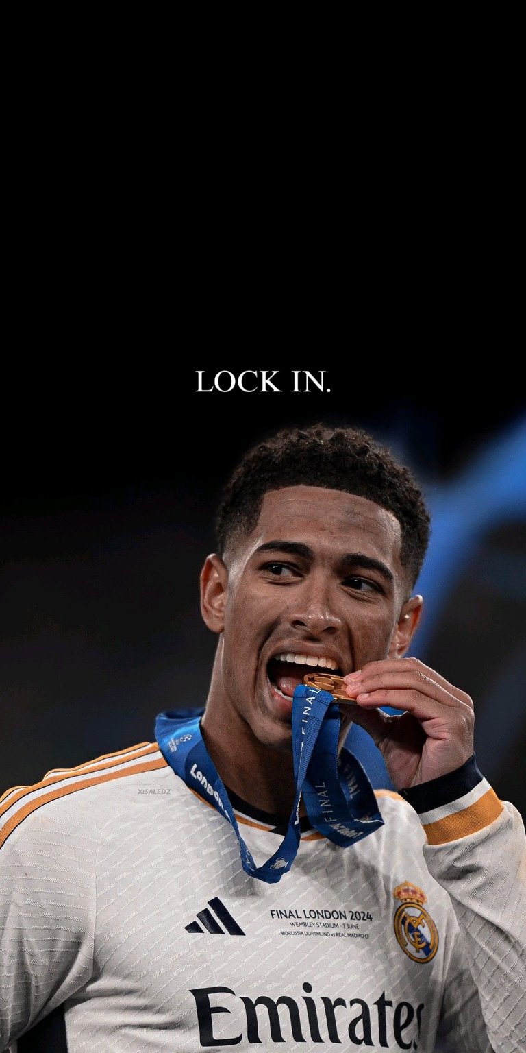 The image shows Jude Bellingham, an English professional footballer for Real Madrid, biting his winner's medal 4k football wallpaper