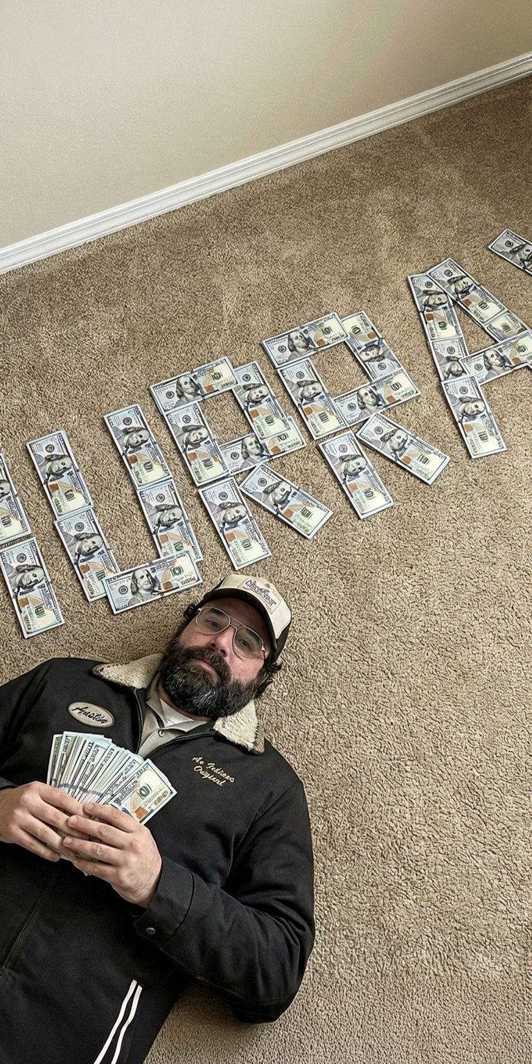 This final live wallpaper features Murray Bauman, the eccentric investigative journalist and conspiracy theorist who becomes an ally to the main group. He is lying on the floor, surrounded by dollar bills that clearly spell out his name, "MURRAY". He is dressed in a dark jacket and a trucker hat, reflecting his rugged, secretive personality. This wallpaper is a tribute to the quirky, resourceful character who helps uncover global plots in Stranger Things.