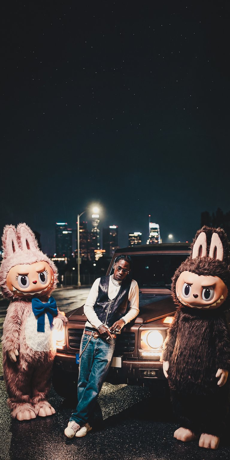 Download this cool Travis Scott & Labubu 4K wallpaper for your iPhone! The unique wallpaper showcases Travis flanked by peculiar Labubu's, set against a backdrop of the city skyline.