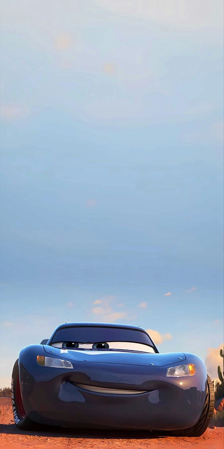 Download this Lightning McQueen wallpaper in stunning 4K resolution for your iPhone. This wallpaper features a blue metallic finish, a smiling expression, and a clear blue sky backdrop.