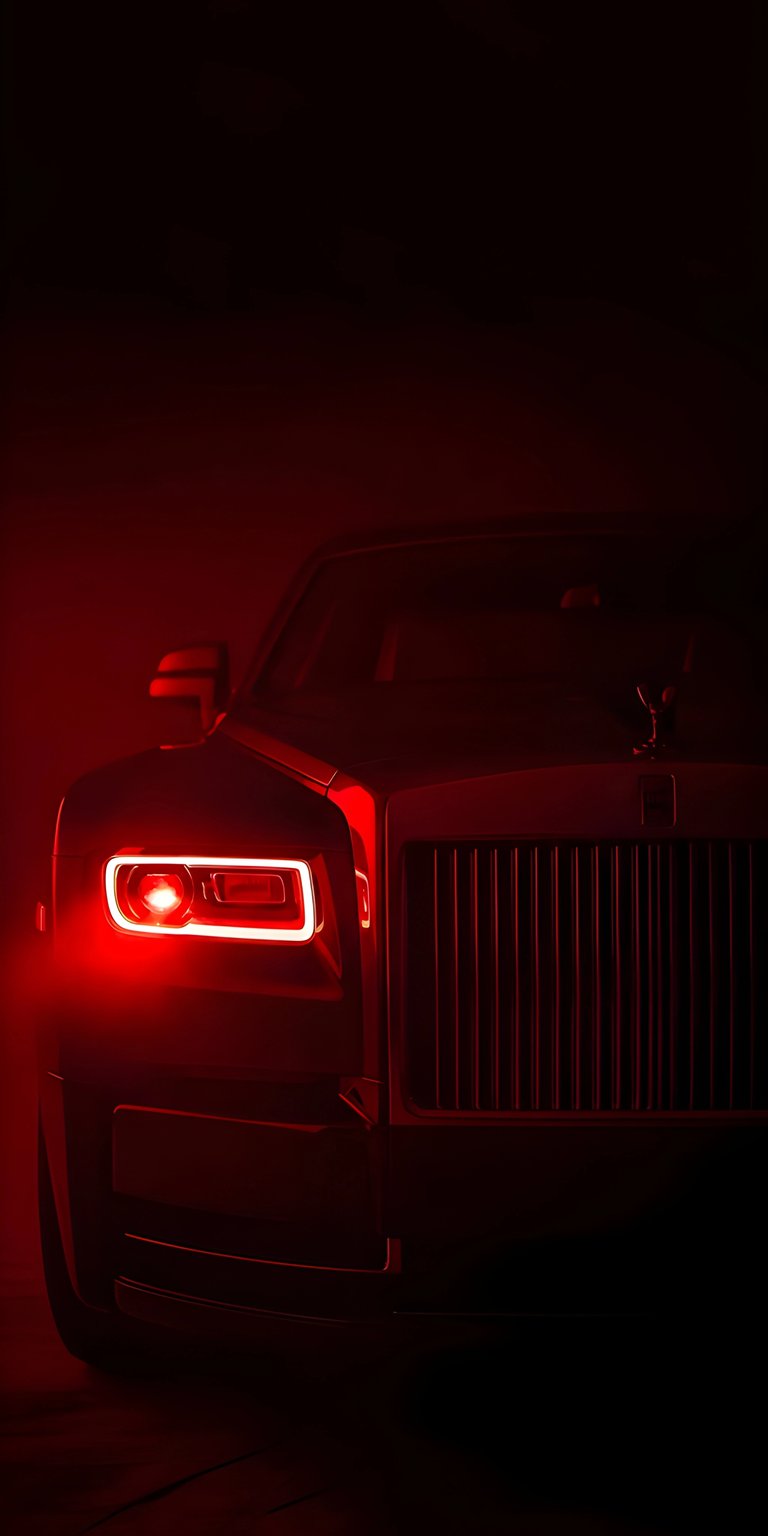 This Rolls-Royce 4K wallpaper is specifically designed to stand out on iPhone screens using deep blacks ideal for OLED wallpapers. The visual features a menacing front-end view of the Cullinan with glowing red headlights and a shadowy, high-contrast mood.