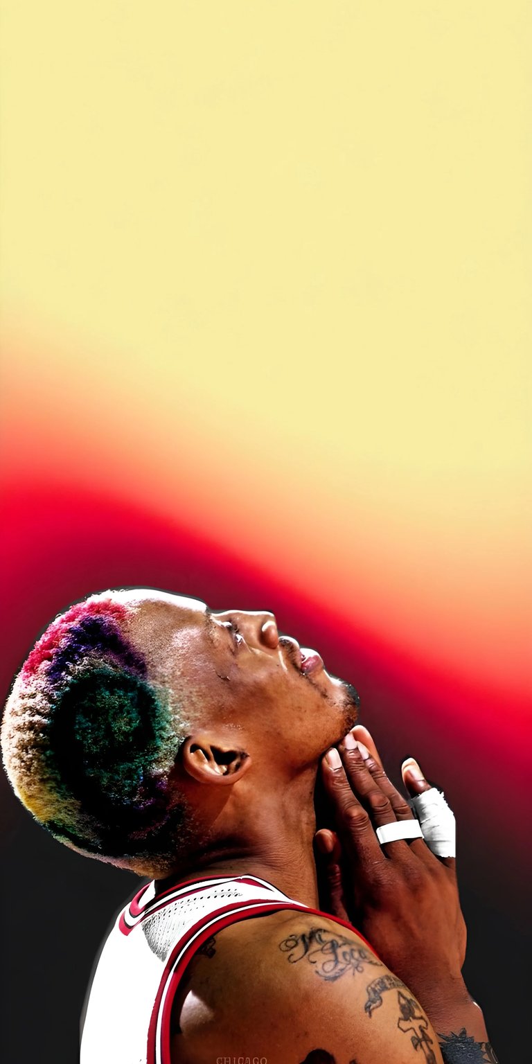 Download this Dennis Rodman 4K wallpaper for your iPhone, showcasing the basketball star with colorful hair and multiple tattoos. This stunning wallpaper captures Rodman looking upwards with his hands clasped together.