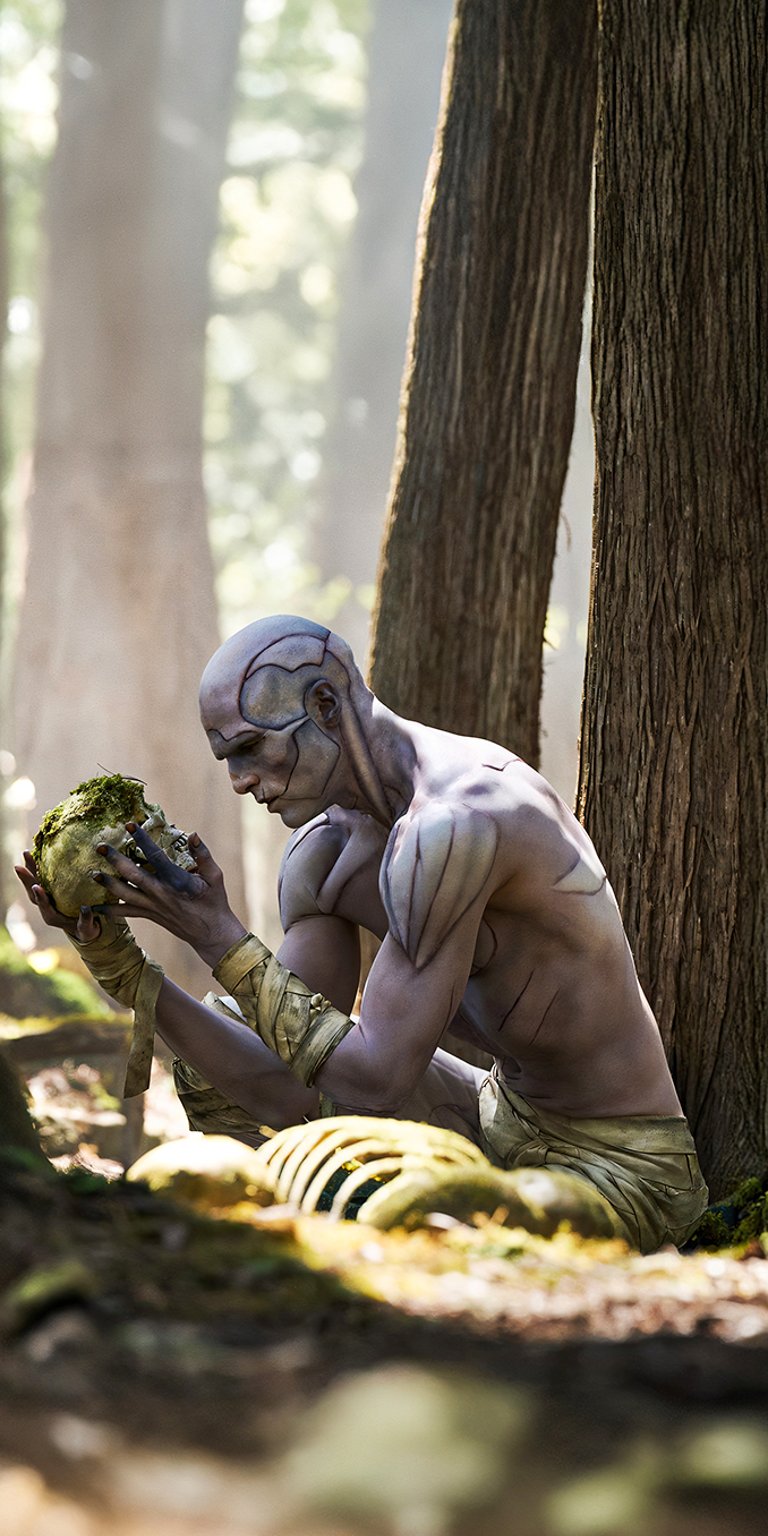 A poignant, sun-dappled scene featuring the Creature (played by Jacob Elordi) from Guillermo del Toro's Frankenstein (2025) in a forest clearing, contemplating a skull. The image captures the character's profound loneliness and intellectual curiosity, offering a deeply atmospheric and artistic backdrop. Ideal for film enthusiasts and those who appreciate dramatic, nature-infused gothic aesthetics.