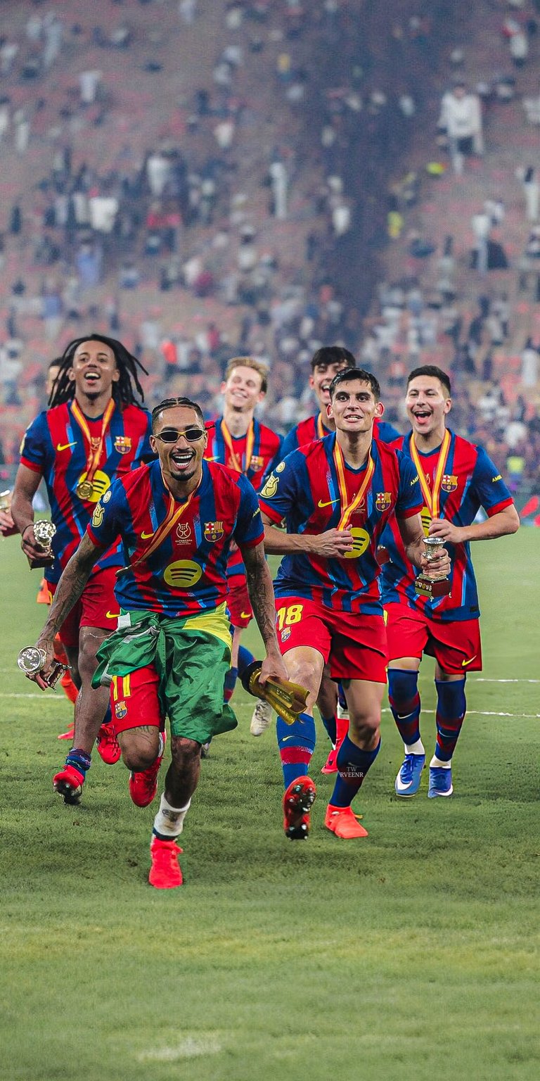 Get hyped with this 4K wallpaper of the Barcelona football team celebrating a recent victory, perfect for your iPhone. The team is seen running on the field with medals and a green cape.