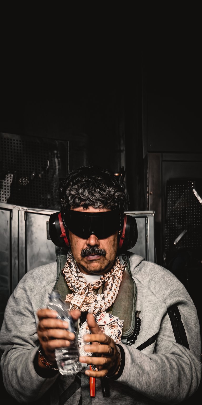 Featuring the "Face of Twitch and YouTube," Dr Disrespect (Herschel Beahm IV) is shown here in his signature "Violence. Speed. Momentum." attire. This wallpaper showcases the 2-time Back-to-Back Blockbuster Champion wearing his iconic Google Prototype sunglasses, red headset, and tactical vest. It’s an edgy, high-contrast portrait designed for hardcore gamers and members of the Champions Club.