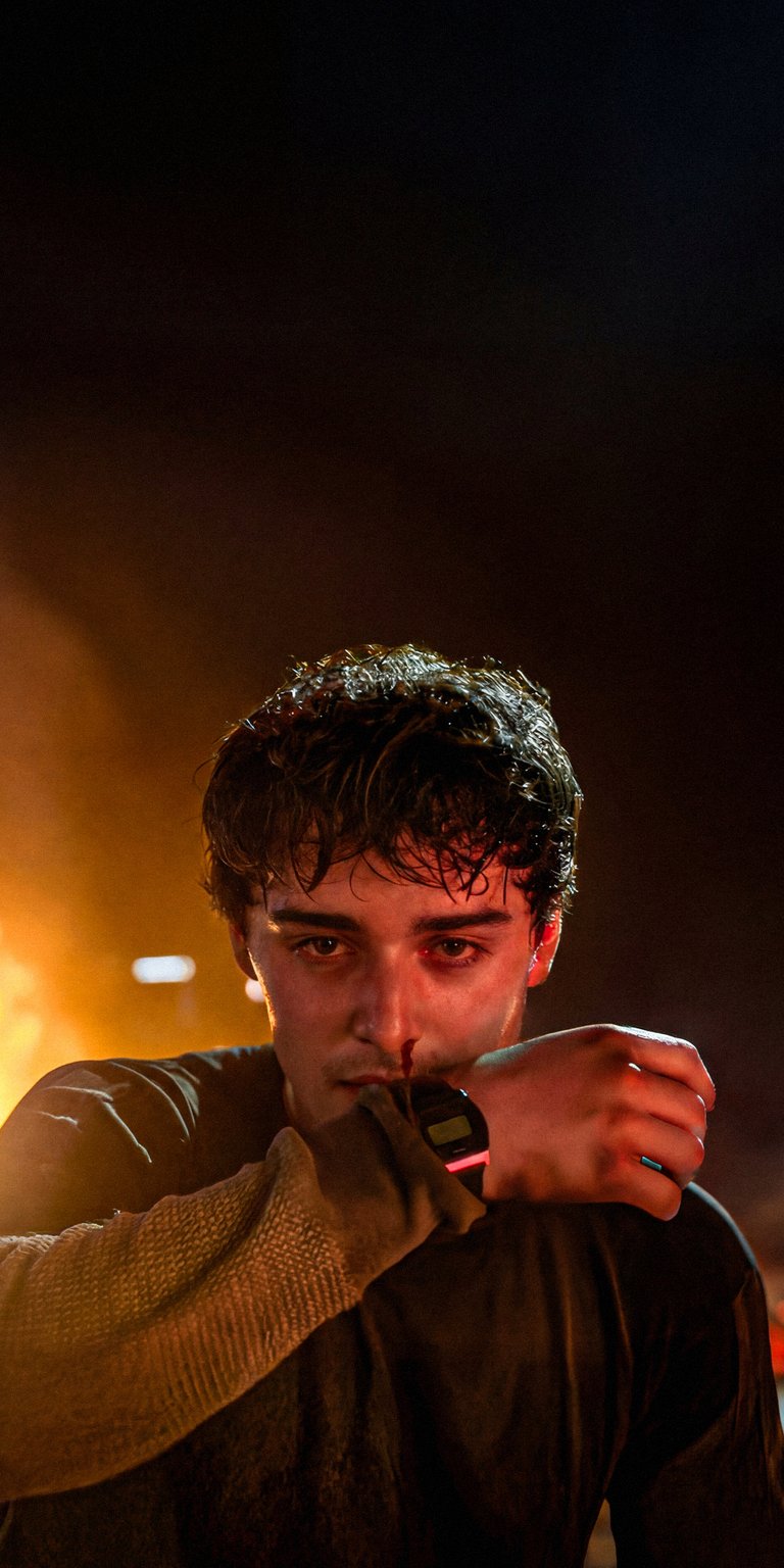 Download this high-quality 4K wallpaper featuring Will Byers (played by Noah Schnapp from Stranger Things) in a dark, intense setting. Perfect for your mobile device.