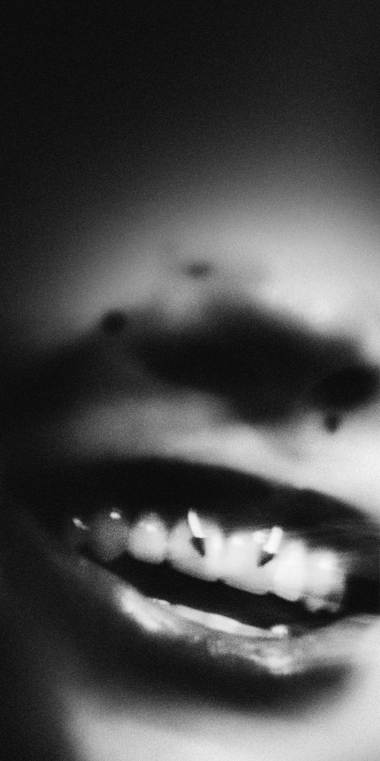 A high-contrast monochrome close-up featuring Alysa Liu showing off silver dental grills. This aesthetic wallpaper offers a gritty, urban look for an iPhone lock screen.
