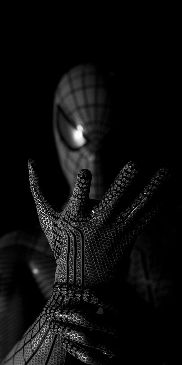 Download this intense Spider-Man black suit 4K wallpaper for your iPhone today, featuring a monochrome aesthetic. This stunning wallpaper showcases the detailed hexagonal pattern on the suit's hand and the glowing eye.