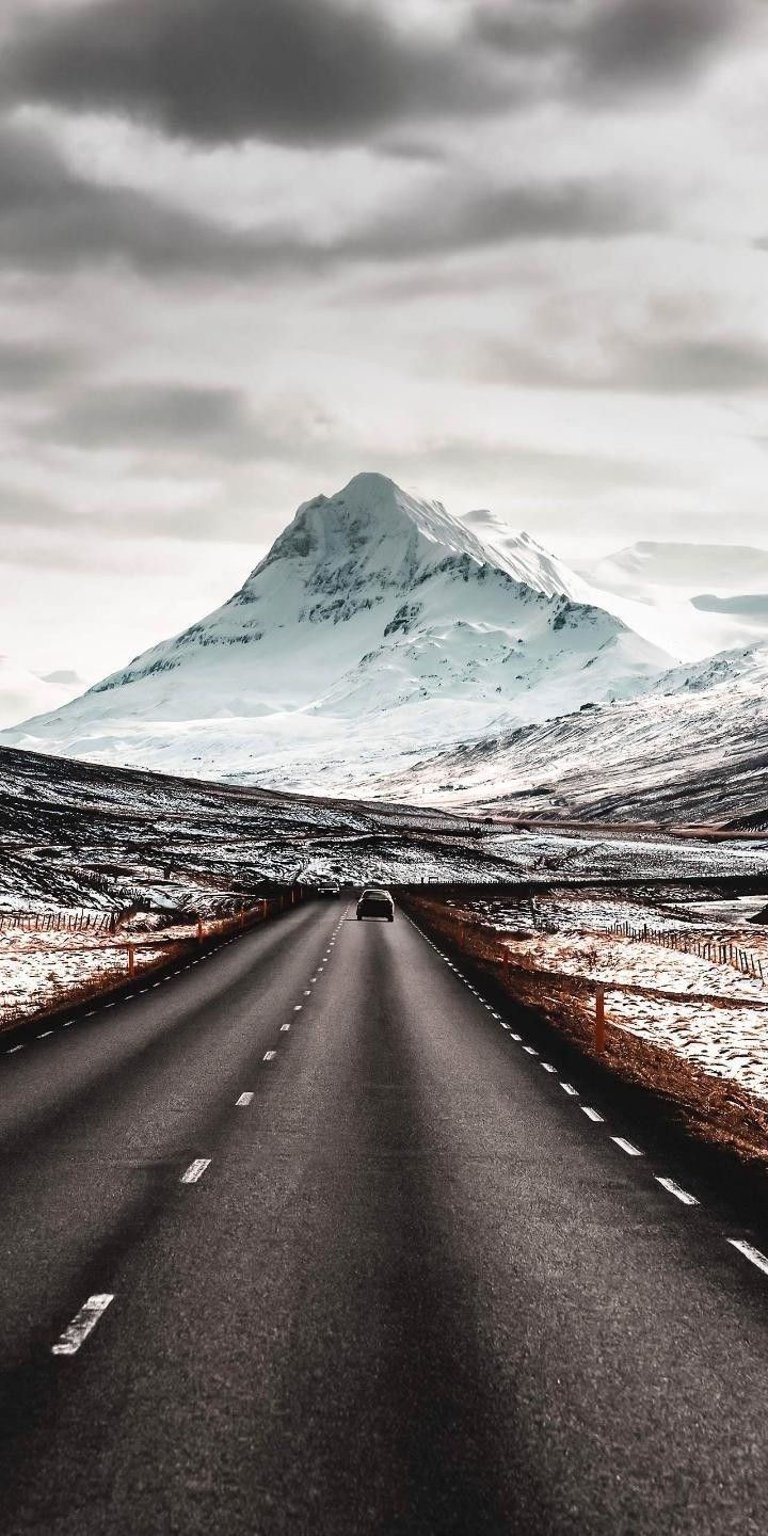Mountain roads with icy mountains at the background wallpaper