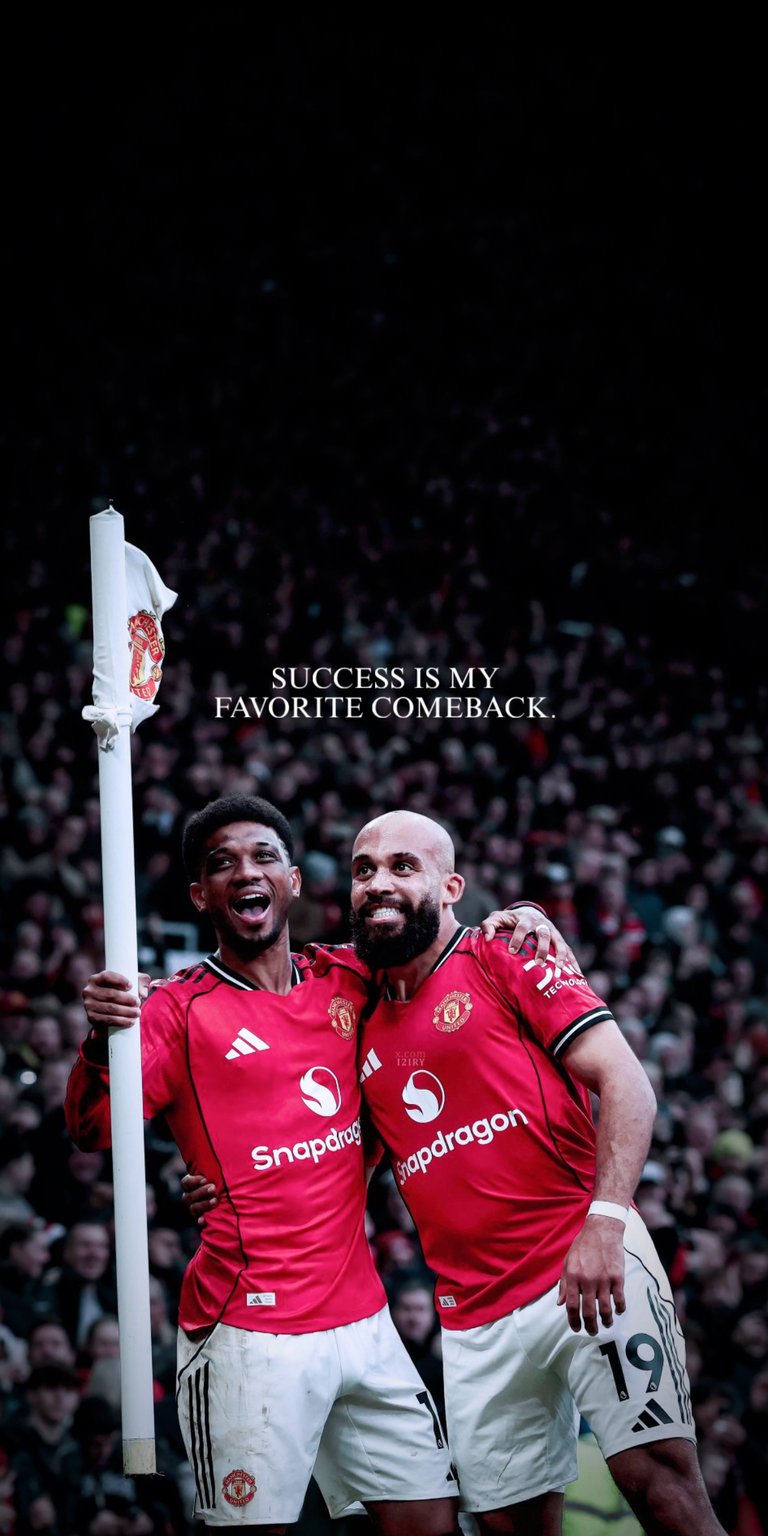 Download this high-quality Amad Diallo and Bryan Mbeumo 4K wallpaper featuring the Manchester United stars celebrating a goal by the corner flag. This vibrant mobile wallpaper is optimized for iPhone and Android, showcasing the sharp details of the iconic red kit and stadium atmosphere in stunning 4K resolution.