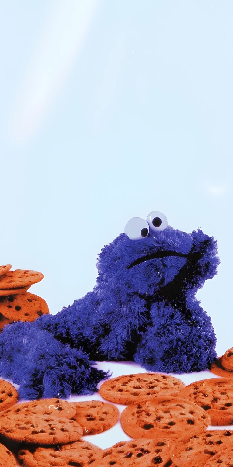 A fun and playful 4K wallpaper featuring the beloved cartoon character, Cookie Monster from Sesame Street, surrounded by his favorite cookies. This high-energy image is a great choice for those who love humor, cartoons, and a touch of nostalgia. It adds a cheerful and funny pop culture element to any mobile device background.