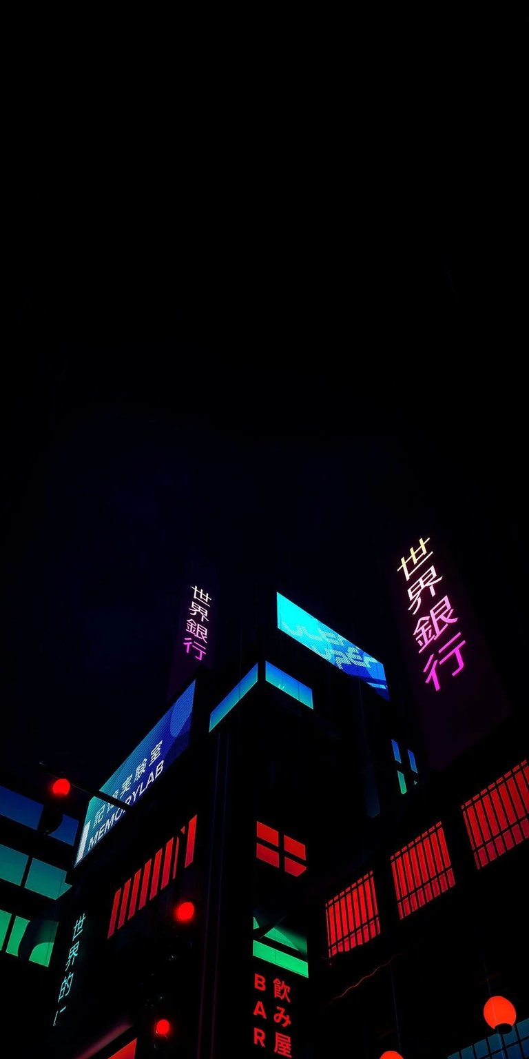 Neon City Night 4K wallpaper displaying glowing signs, dark sky contrast, and vibrant cyberpunk lighting. This AMOLED wallpaper looks striking on iPhone lock screen and home screen with deep blacks and bright neon accents.