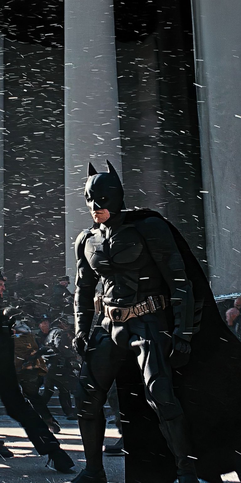 Download this Batman 4K wallpaper for your iPhone, showcasing the Dark Knight in his iconic suit. This stunning wallpaper features Batman amidst a snowy backdrop, highlighted by the stark contrast of his cape and utility belt.