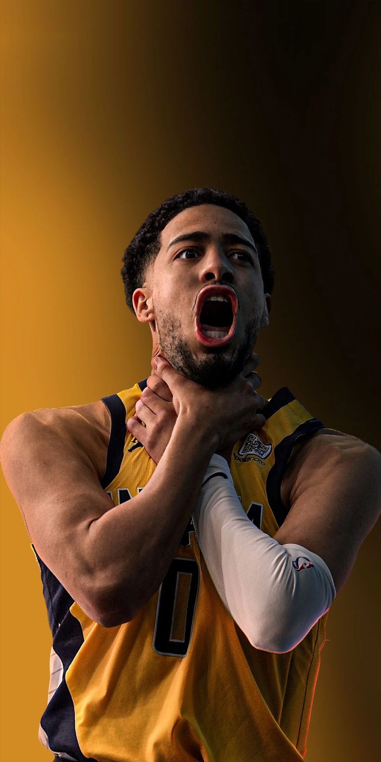 Download this high-quality Tyrese Haliburton 4K wallpaper for your iPhone, featuring his open mouth, yellow jersey and white arm sleeve. This wallpaper is perfect for any basketball fan.