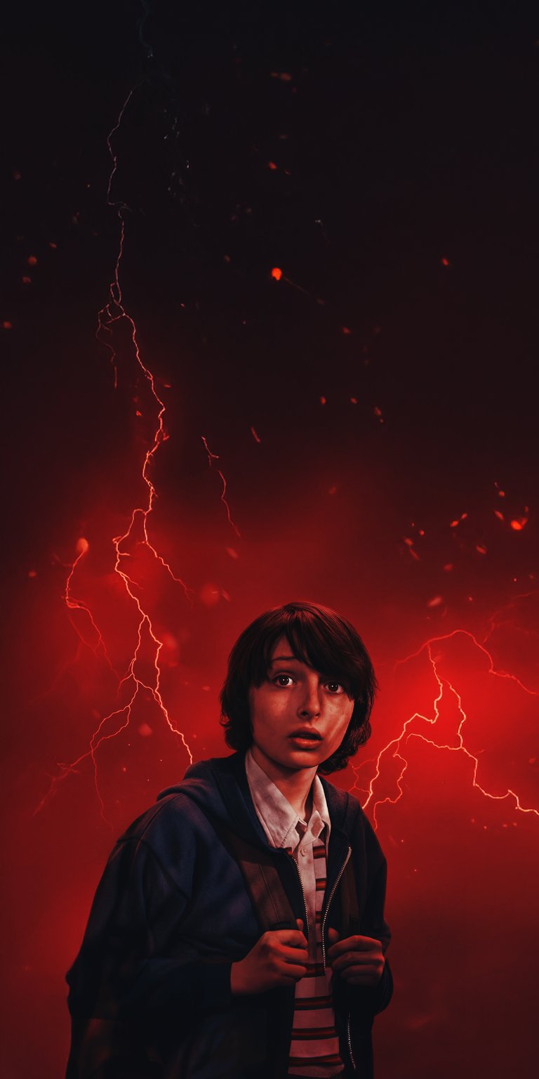 Download this stunning Mike Wheeler 4K wallpaper for your iPhone, featuring an intense red lightning storm. This wallpaper showcases Mike's worried expression and the dark shadows around him.