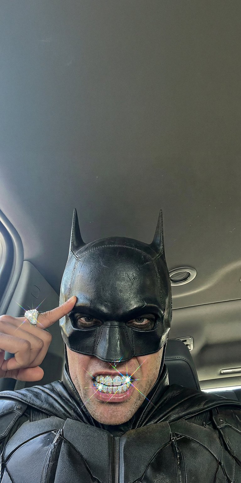 This 4K aesthetic wallpaper features a realistic Batman rocking iced-out diamond grillz and a matching ring while posing inside a vehicle. Elevate your iPhone with this high-detail wallpaper showcasing textured black leather and brilliant, shimmering lens flares for a bold urban mood.