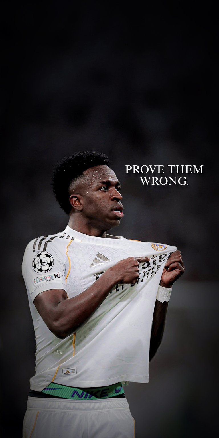 Vinicius Junior holding his white jersey in a dramatic stadium scene with dark tones and powerful spotlight effect. This 4K wallpaper enhances your iPhone display with sharp contrast and a modern aesthetic wallpaper look.