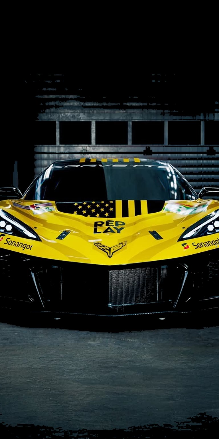This high-contrast OLED / AMOLED wallpaper features a yellow Chevrolet Corvette C8.R race car emerging from the shadows. Optimized for iPhone, the wallpaper showcases aggressive carbon fiber details and bold racing decals under sharp studio lighting.