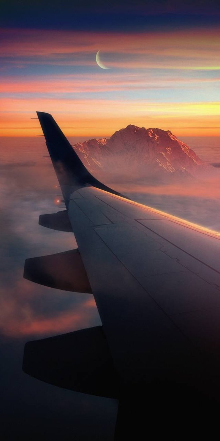 Plane flying on the clouds with moon view wallpaper 4K