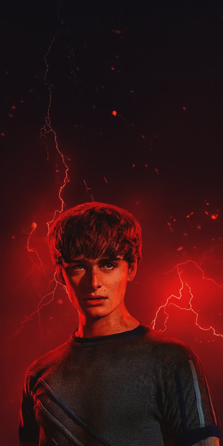 Download this striking Will Byers 4K wallpaper for your iPhone, showcasing electric red lightning and ominous red embers. This wallpaper highlights his intense gaze and serious expression.