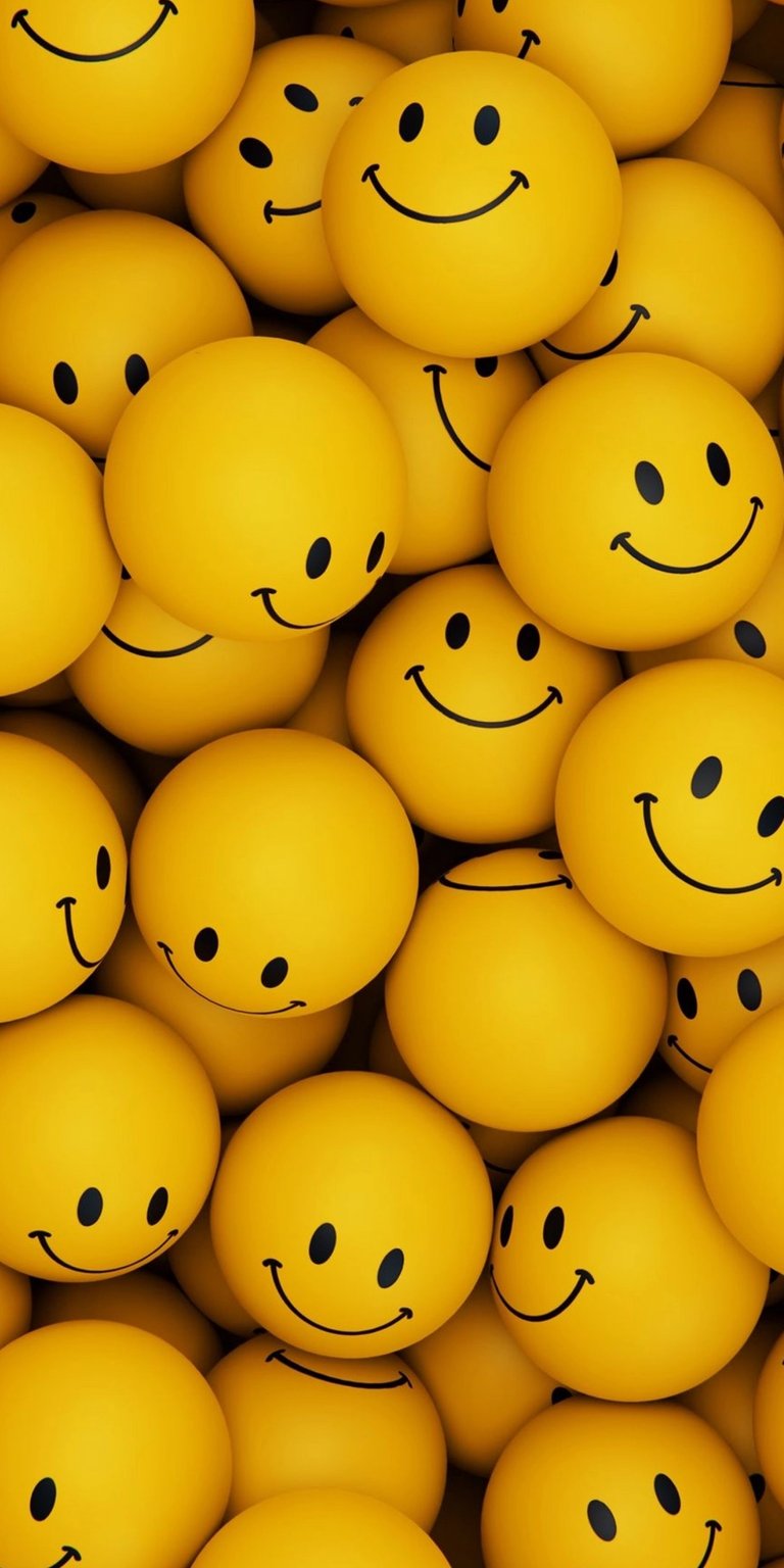 Brighten your iPhone with this smiley faces wallpaper in stunning 4K resolution. The wallpaper showcases numerous yellow emoji-like spheres with simple black smiles and dot eyes, creating a cheerful and lighthearted visual.