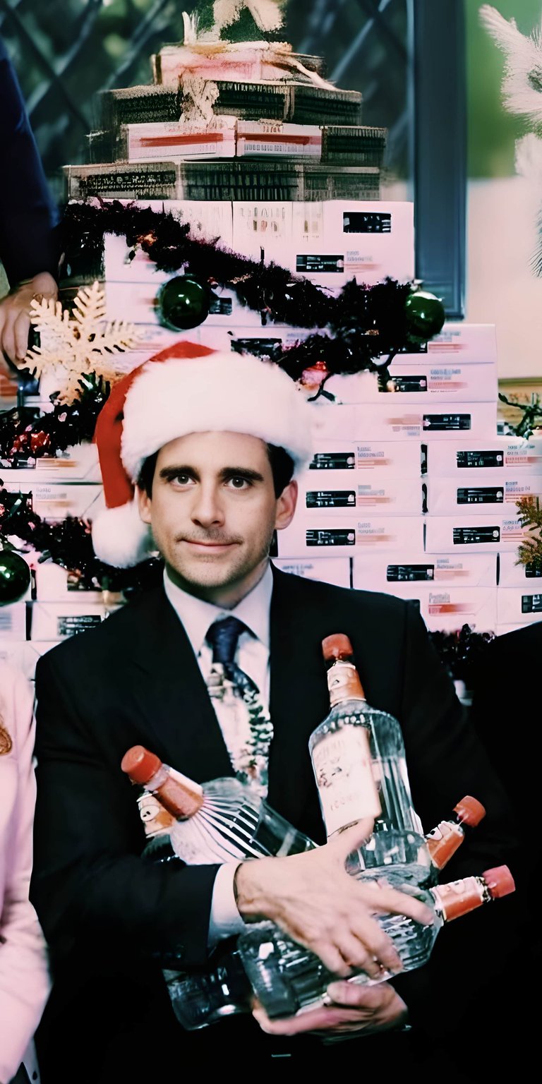 Download this funny Michael Scott 4K wallpaper for your iPhone! This wallpaper features Michael Scott wearing a Santa hat, holding numerous bottles, with a Christmas tree made of boxes in the background.