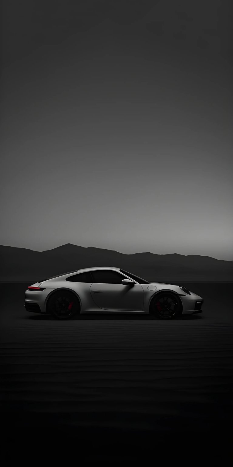 Download this stunning Porsche wallpaper in 4K for your iPhone, showcasing its sleek design. The low-angle shot reveals the car's aerodynamic profile, enhanced by the backdrop of distant mountains and unique terrain.