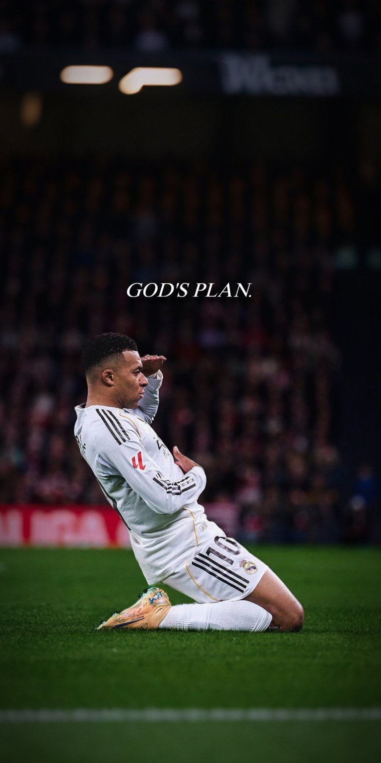 A high-action shot of Kylian Mbappé performing his signature knee slide celebration in the iconic white Real Madrid kit. The wallpaper features the elegant "GOD'S PLAN" typography, capturing the intensity and faith of one of the world's best players.