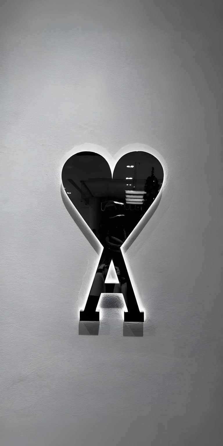 AMI Paris logo 4K wallpaper designed as a clean iPhone wallpaper with a refined, modern feel. This minimalist wallpapers style wallpaper features monochrome tones, soft backlighting, and generous negative space for a calm luxury look.