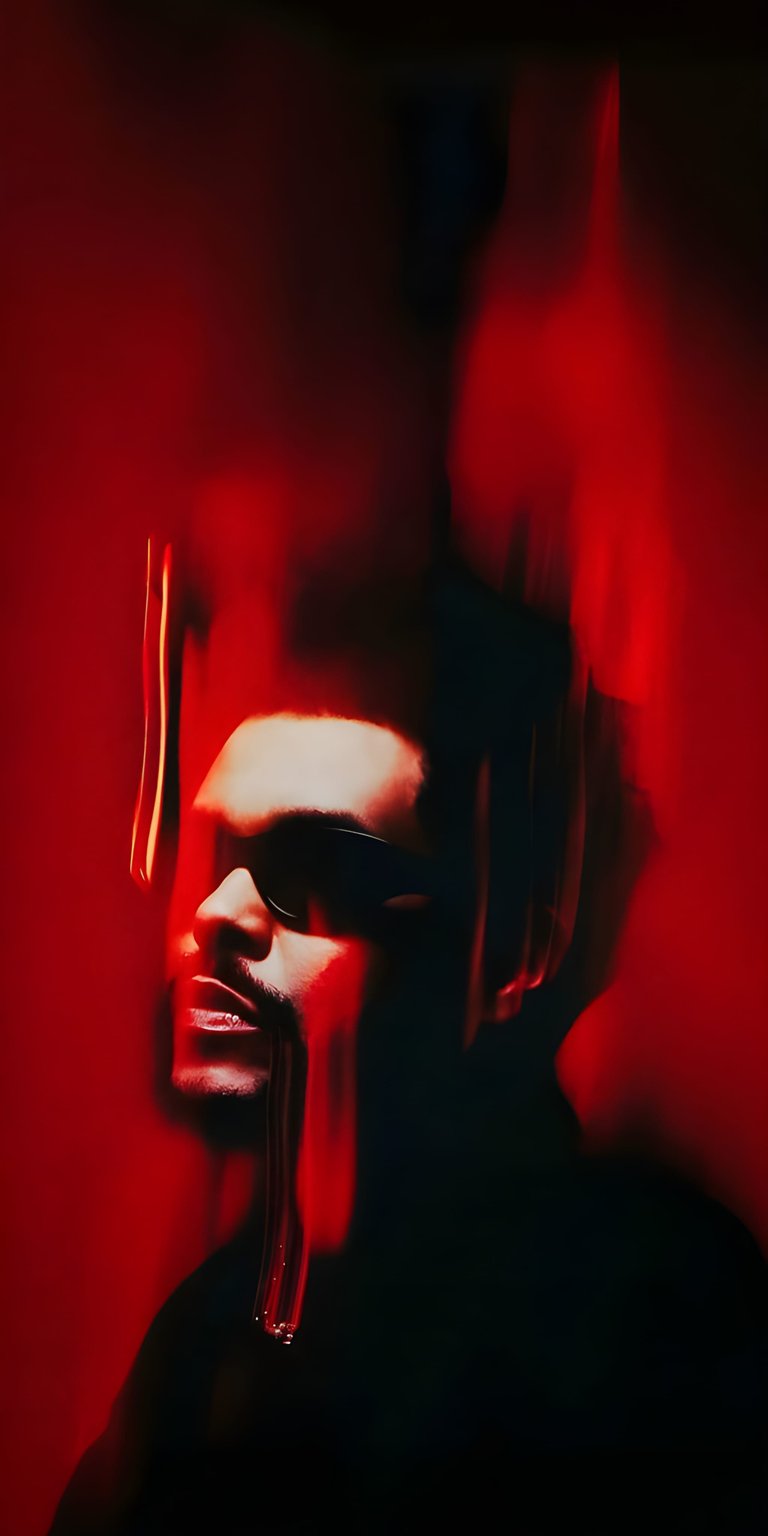 Get this stunning 4K wallpaper of The Weeknd for your iPhone. This wallpaper features a profile shot of The Weeknd against a red backdrop, complete with dripping accents and dark sunglasses.