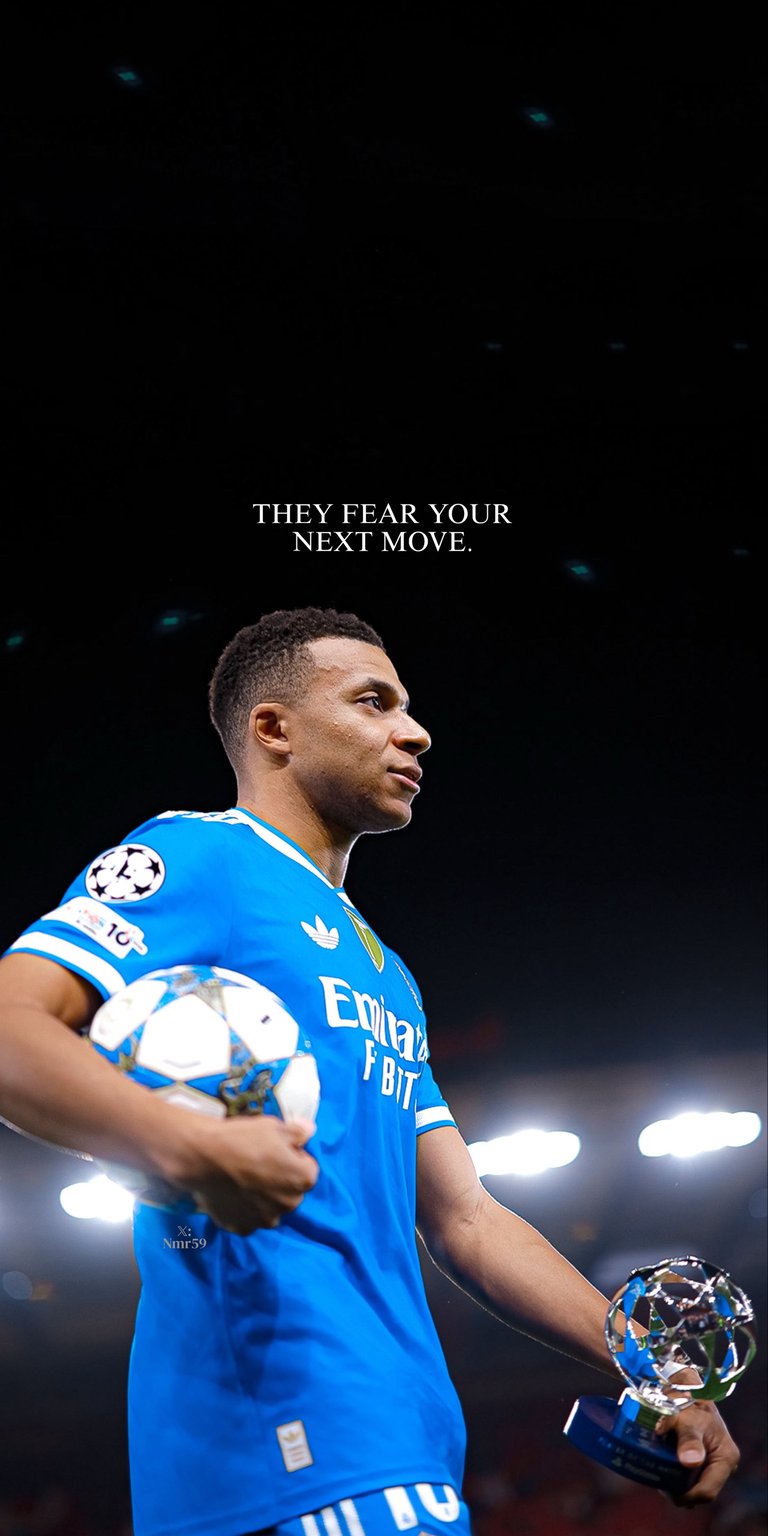 An intense 4K wallpaper featuring Real Madrid forward Kylian Mbappé in his new number 10 jersey, holding a Champions League trophy and match ball. The motivational text "THEY FEAR YOUR NEXT MOVE" captures his winning mentality.