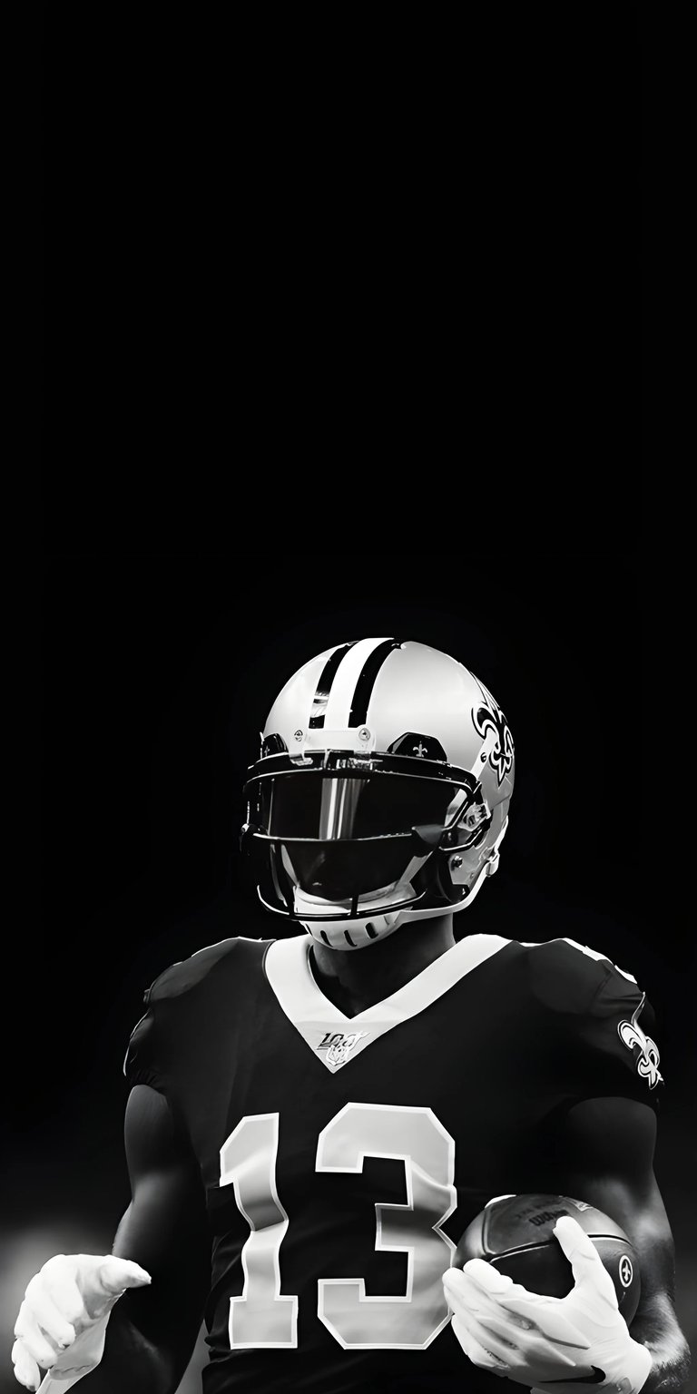 Download this striking Michael Thomas 4K wallpaper for your iPhone, showcasing his iconic helmet, the number "13" jersey, and a textured football clutched in his gloves. This high-resolution wallpaper will make any iPhone screen pop!