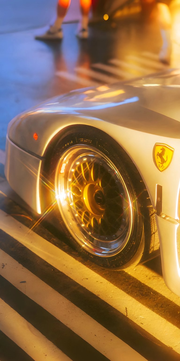 Capture the essence of Italian automotive excellence with this stunning Ferrari F40 wallpaper in 4K, perfect for your iPhone. The golden rims gleam beneath soft lighting, while the iconic Prancing Horse badge stands out against the car's sleek silver paint job.