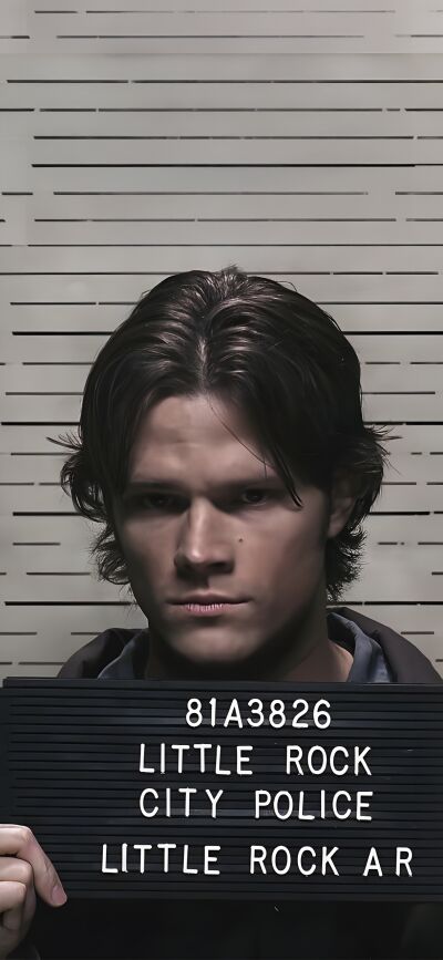 This 4K wallpaper features Sam and Dean Winchester with a sign written "Little Rock City Police" for iPhone. This matching wallpaper is perfect for Supernatural fans who want to share a fun image across two phones.