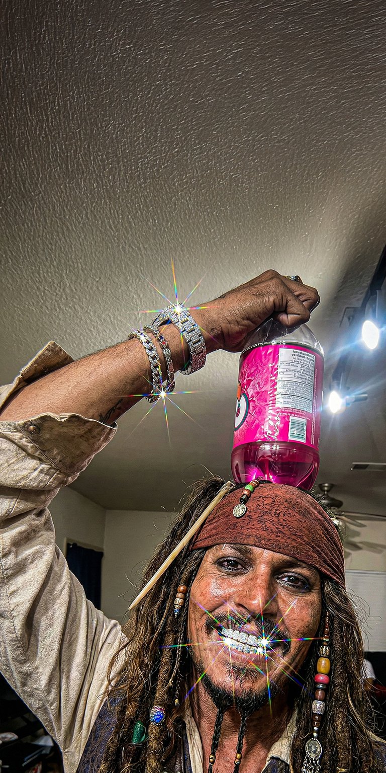 This high-energy 4K wallpaper features Captain Jack Sparrow sporting diamond grillz and luxury jewelry for a unique iPhone look. This aesthetic wallpaper highlights vibrant pink accents from the soda bottle and sparkling lens flares against a neutral interior background.