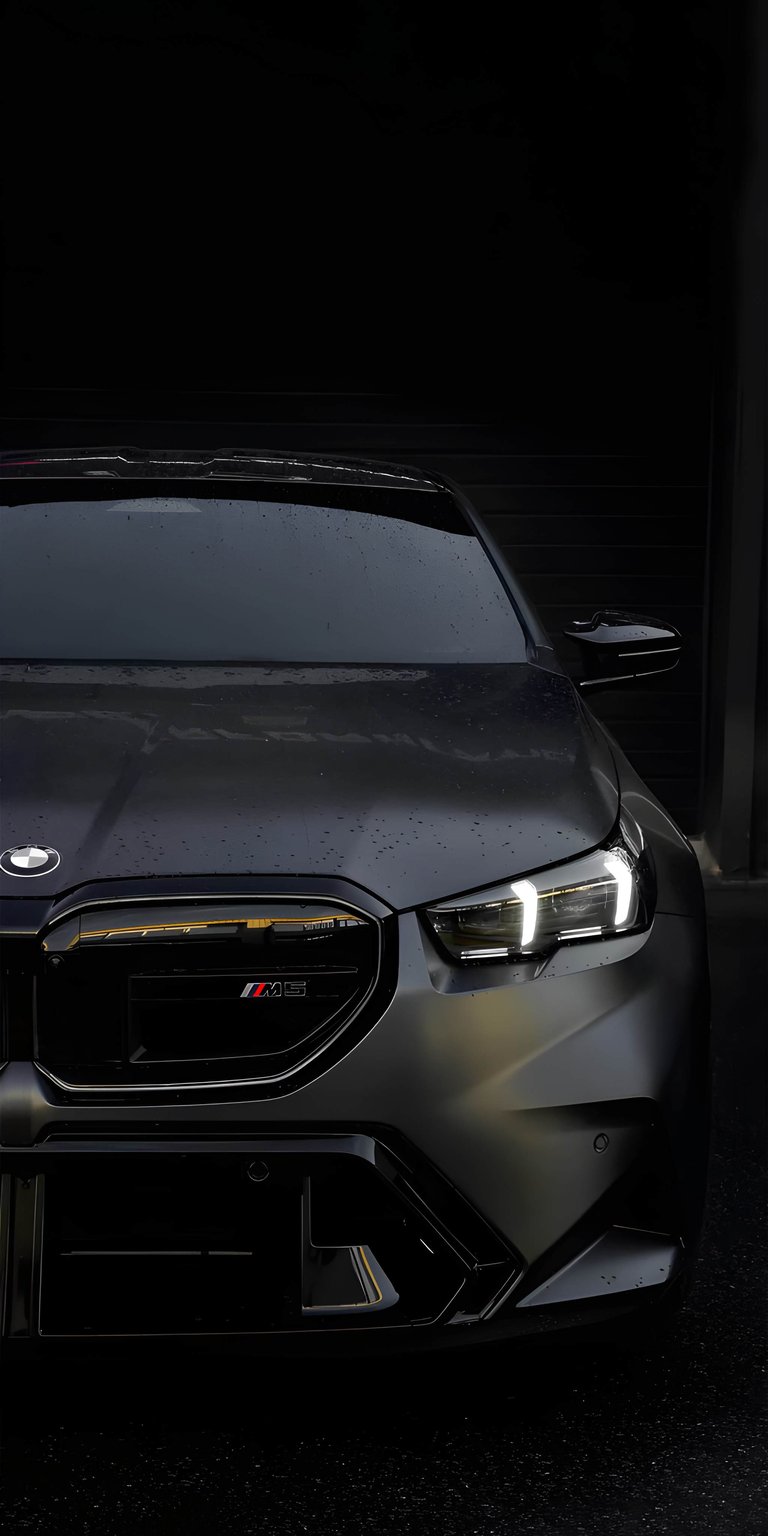 Experience the aggressive presence of the BMW M5 G90 with this high-contrast 4K wallpaper designed specifically for iPhone. This OLED / AMOLED wallpaper features a stealthy matte black finish with glowing LED headlights reflecting off a rain-slicked surface.