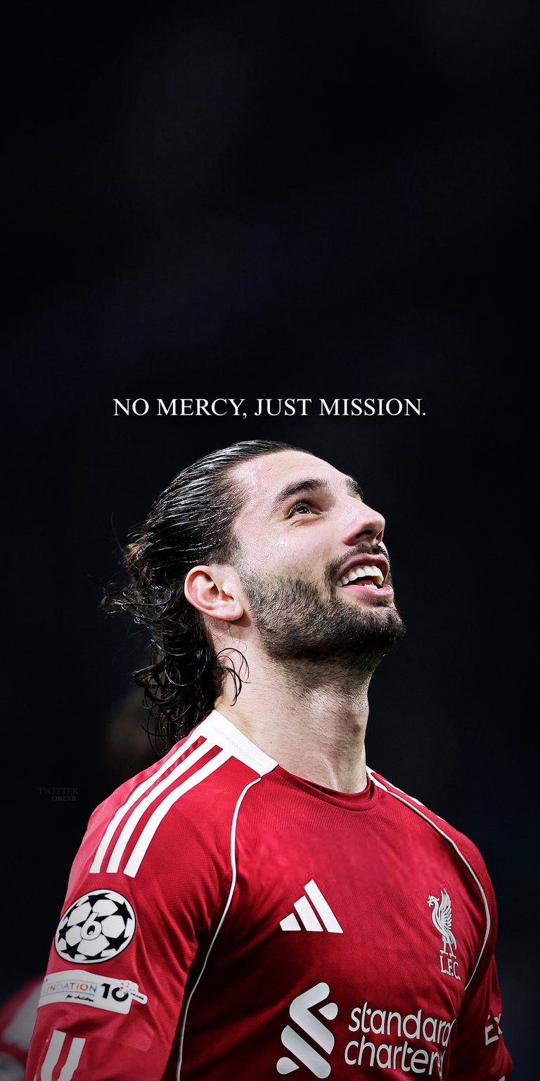 Elevate your device with this Dominik Szoboszlai 4K wallpaper featuring the Liverpool midfielder looking upward in his red home kit. This professional 4K wallpaper is optimized for iPhone and Android users who want a clean, motivational Premier League aesthetic.