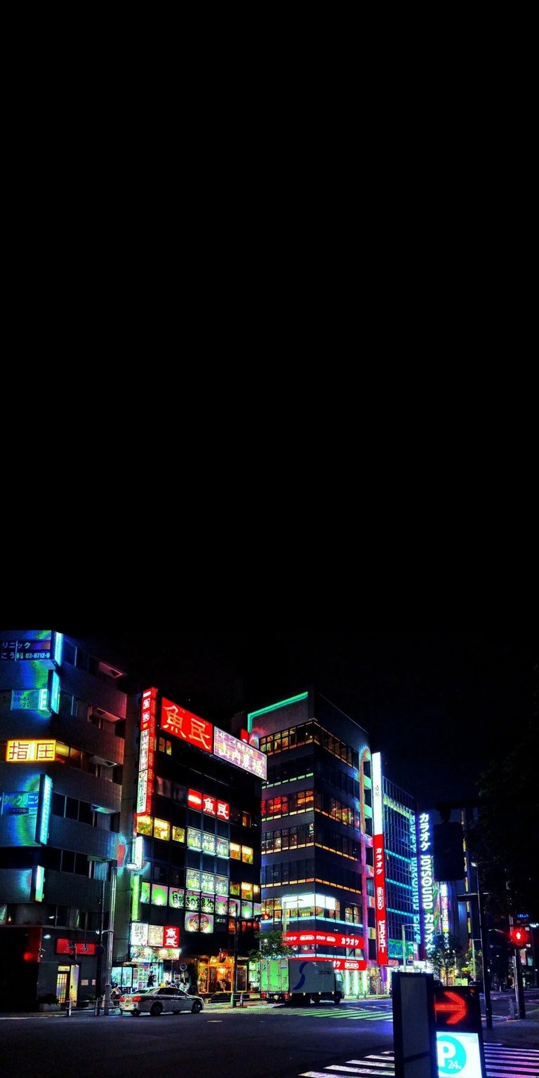 City Night Static wallpaper showcasing glowing neon buildings, colorful street lights, and deep black night contrast. This AMOLED wallpapers style wallpaper adds bold urban energy to your iPhone lock screen and home screen.