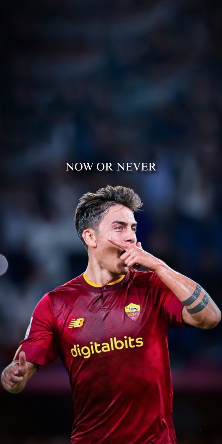 This high-quality 4K wallpaper captures Paulo Dybala in his iconic "Dybala Mask" celebration pose while wearing the AS Roma kit. The design features a moody, dark aesthetic with the motivational text "NOW OR NEVER" centered at the top. Perfect for fans of "La Joya" looking for a clean, professional, and inspiring background for their mobile devices.