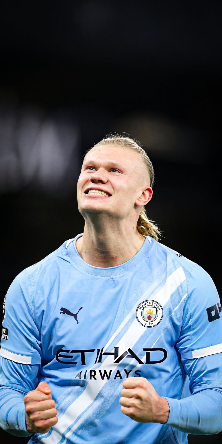 Get this vibrant Erling Haaland 4K wallpaper for your iPhone, featuring the smiling footballer with a slicked-back hairstyle in a light blue jersey. This wallpaper captures the player's celebratory expression and the 'Etihad Airways' logo on the jersey.