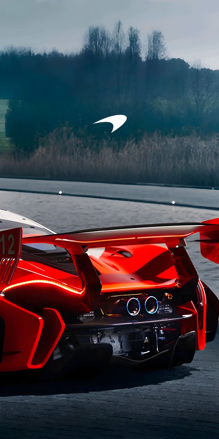 This high-performance McLaren Senna GTR 4K wallpaper captures the aggressive rear aerodynamics and glowing LED taillights of the track-only supercar. Designed specifically for your iPhone, this aesthetic wallpaper features a striking red finish and exposed carbon fiber details against a soft, cinematic outdoor backdrop.